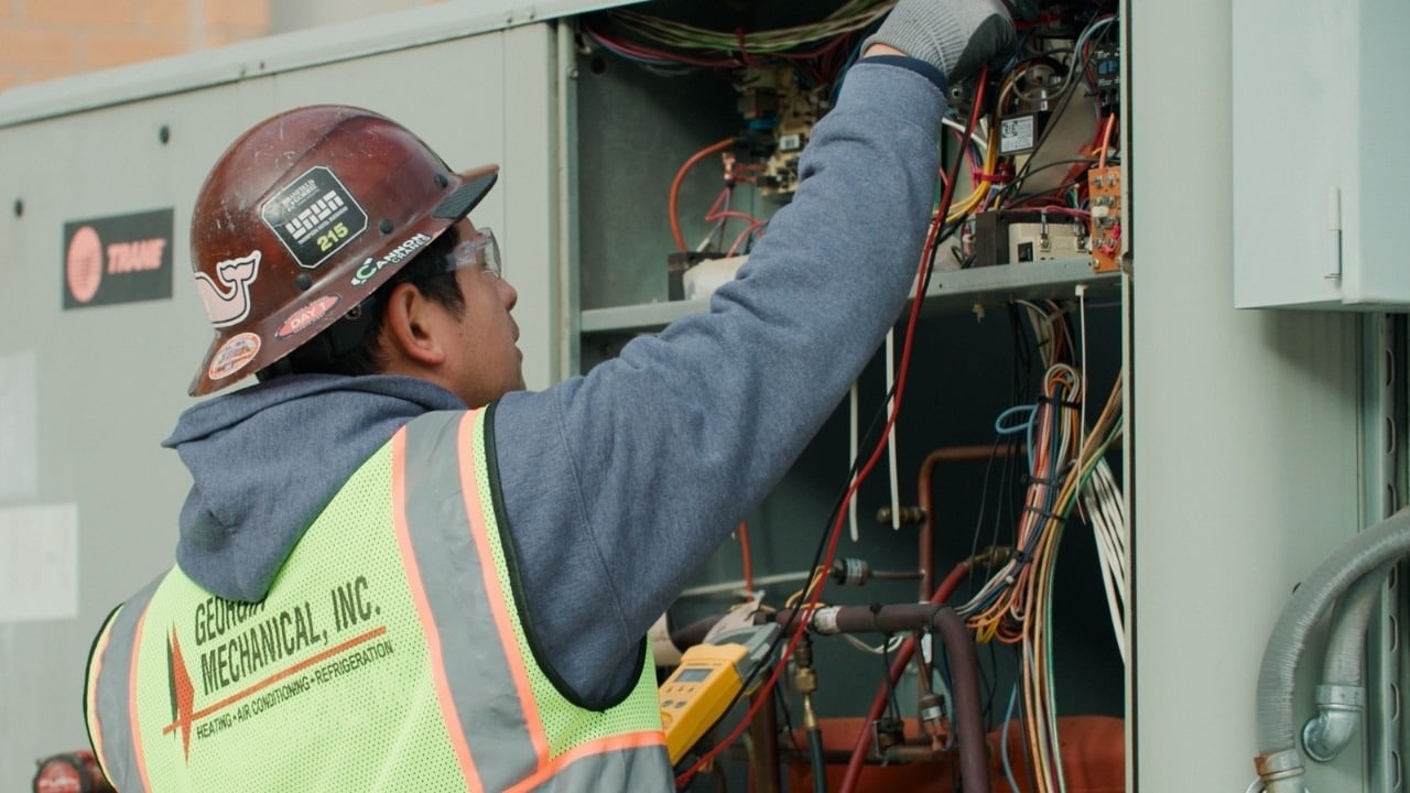 Georgia Mechanical technician checking the controls of a commercial unit